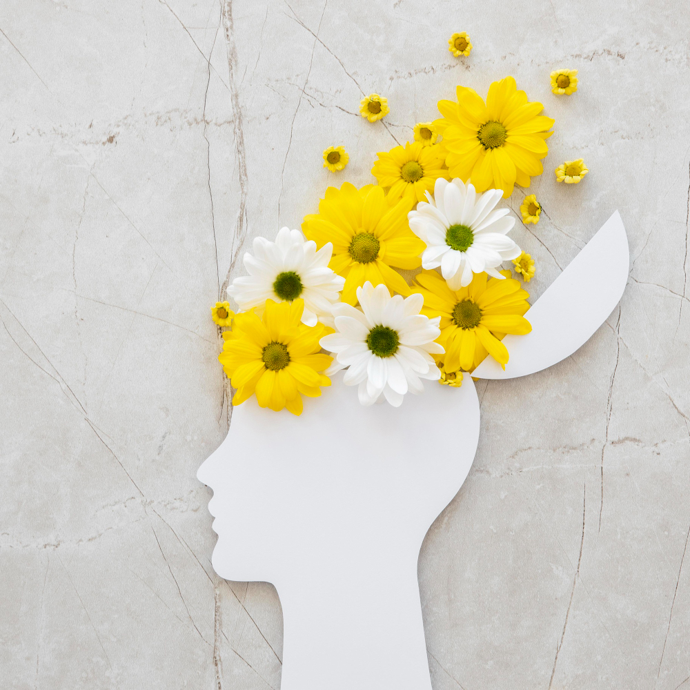 un dessin de fleurs jaunes et blanches qui sortent d'un cerveau féminin